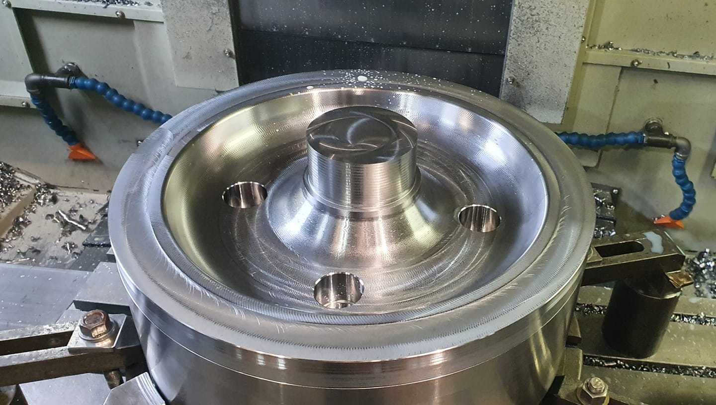 Large machined housing set up on a CNC machine table